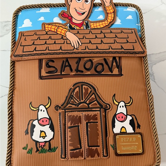 Loungefly Handbags - Loungefly Toy Story Woody Saloon 30th Anniversary mini backpack,NWT